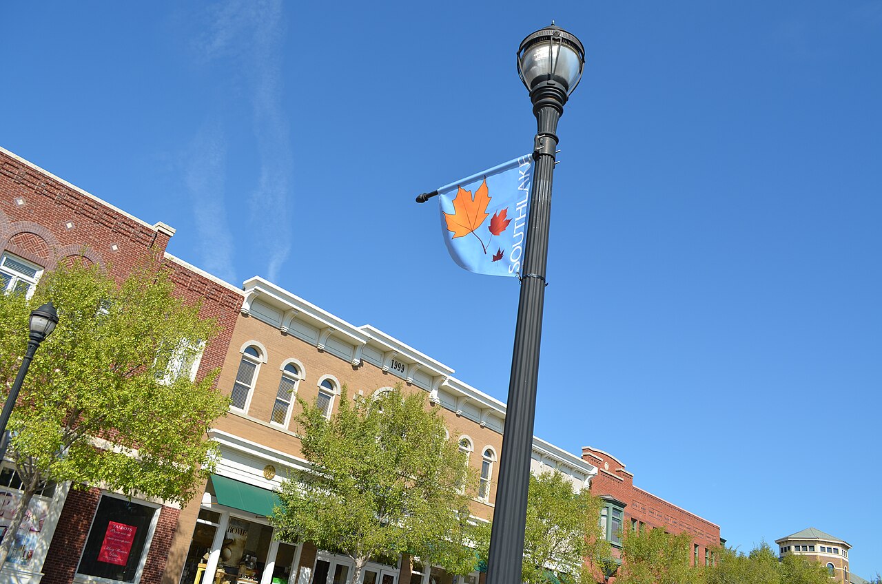 Shops, trees and a street lamp in Southlake Town Square, September 2011